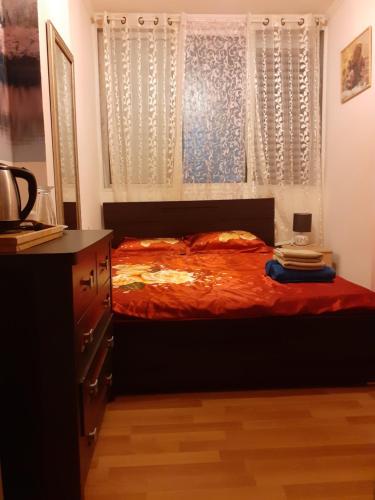 a bedroom with a bed with a window and a dresser at Room/Rooms for 1/2 Guests in Haifa