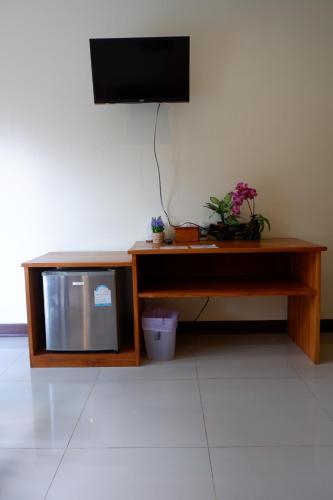 a tv on a wooden table with a television on top at Khao Sok Nature Place - SHA Certified in Khao Sok
