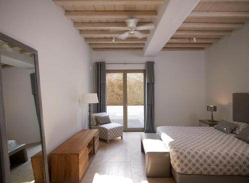 a bedroom with a bed and a couch and a mirror at ABSOLUTE PARADISE in Paradise Beach
