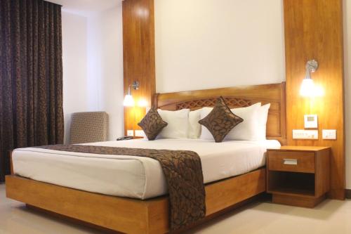 a bedroom with a large bed in a hotel room at The Hotel Canoe in Kannur