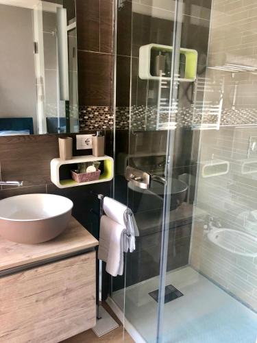 a bathroom with a sink and a glass shower at A casa di V-Ale in Treviso
