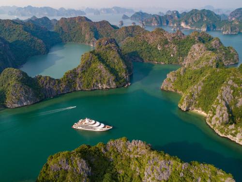 a cruise ship in the middle of a mountain lake at Scarlet Pearl Cruises - Wonder On Lan Ha Bay in Ha Long