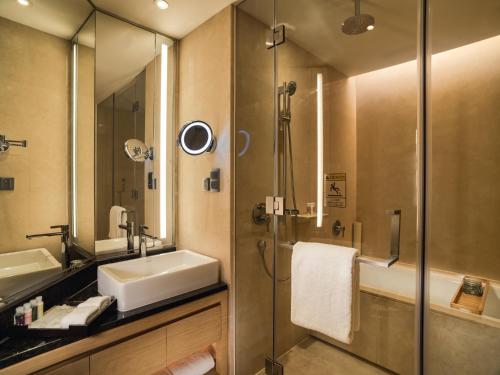 a bathroom with a sink and a shower at Fraser Suites Guangzhou in Guangzhou
