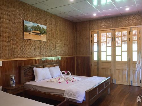 Кровать или кровати в номере MEKONG NATURE LODGE