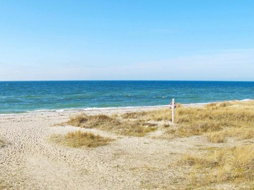 an empty beach with the ocean in the background at 8 person holiday home in Dannemare-By Traum in Dannemare
