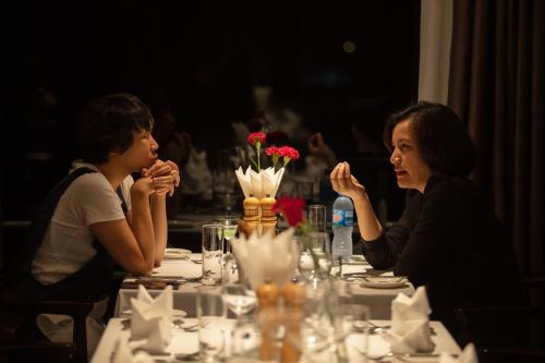 a couple of people sitting at a table at Scarlet Pearl Cruises - Wonder On Lan Ha Bay in Ha Long