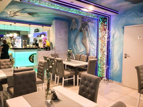 a restaurant with a mermaid mural on the wall at Gwiazda Morza in Rewal