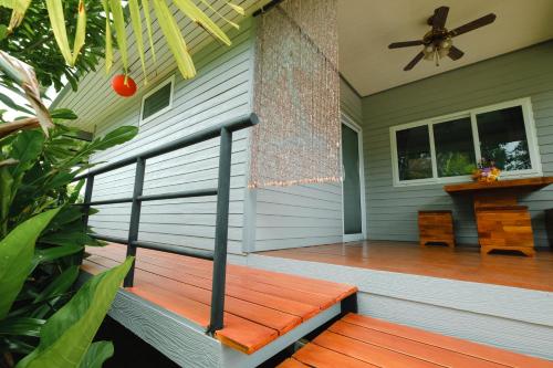a porch with a wooden bench on a house at Saree Lagoon Villa Koh Samui in Lipa Noi