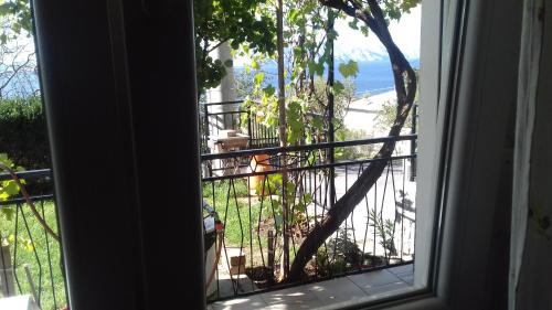 a window view of a balcony with a view of the ocean at Apartment Skale in Senj