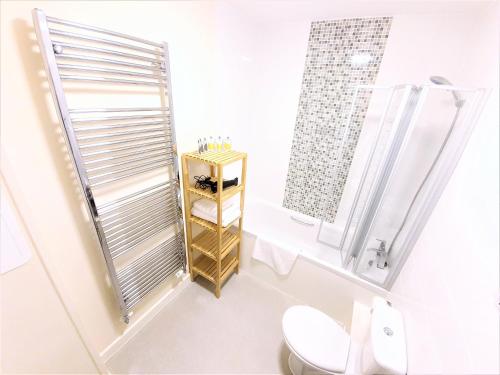 a bathroom with a toilet and a shower at Salford Holiday Apartment Manchester in Manchester