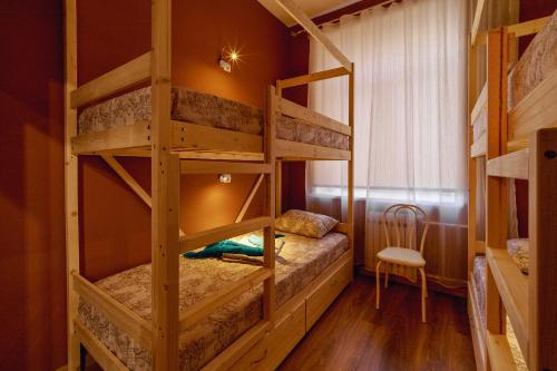 a bedroom with two bunk beds in a room at 1STHOSTEL in Achinsk