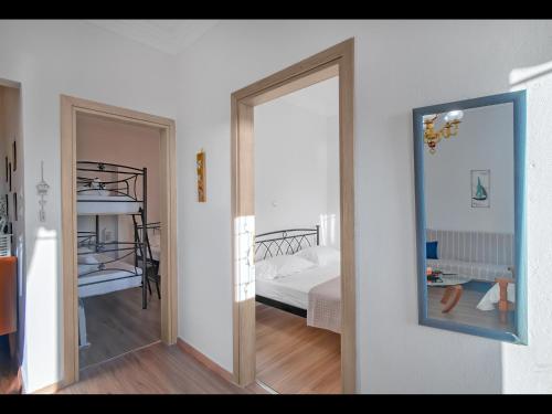 a room with a bedroom with a bed and a mirror at CHEZ KONSTANTINOS in Kallirakhi