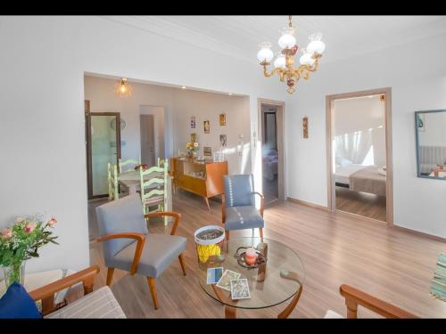 a living room with a couch and a dining room at CHEZ KONSTANTINOS in Kallirakhi