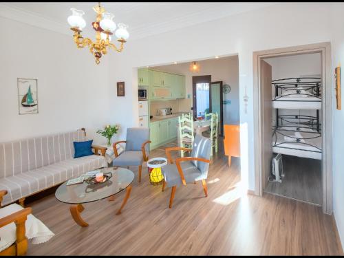 a living room with a couch and a table at CHEZ KONSTANTINOS in Kallirakhi