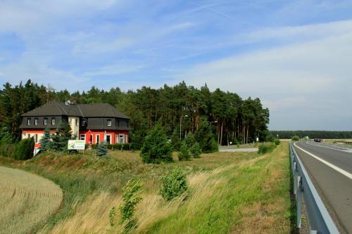 a house on the side of a road next to a highway at Penzion v Zálesí in Mladá Boleslav