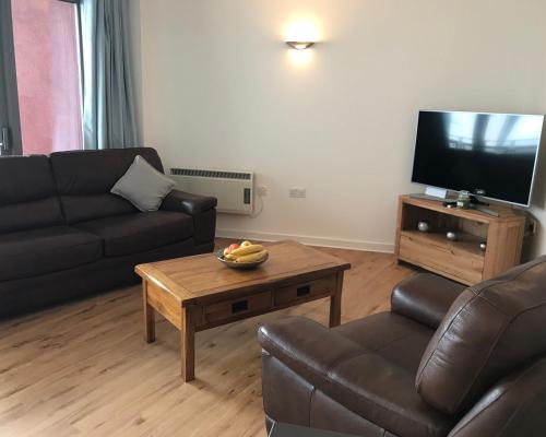 a living room with a couch and a coffee table at California Building in London