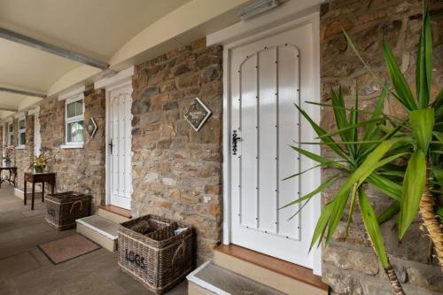 a hallway with a door and a stone wall at Middlehead Cottages in Pickering