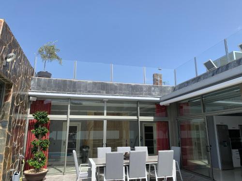 a table and chairs on the patio of a building at Suecia Villa Opal Anfi Tauro in Mogán