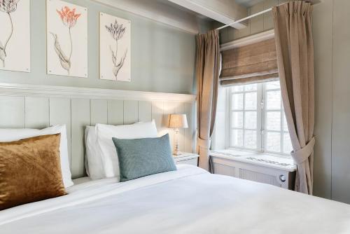 a bedroom with a white bedspread and a white comforter at Logement Petit Beijers in Utrecht
