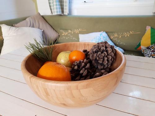 a wooden bowl of fruit on a table at The PineForest Cabin in Chiclana de la Frontera