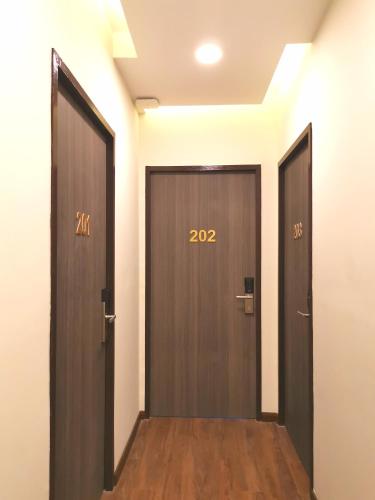 two doors with numbers on them in a hallway at HotSpot @ City Centre by SSVC in Kota Kinabalu