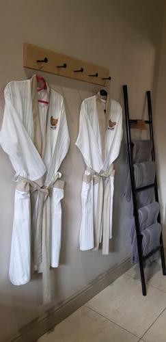 a group of robes hanging on a wall at Luvivane Luxury Villa in Marloth Park