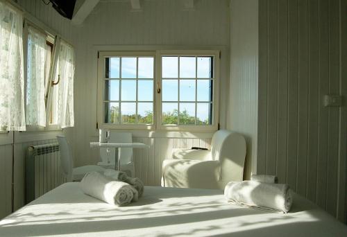 a bedroom with a bed and two chairs and a window at Junior Suites Venezia in Venice