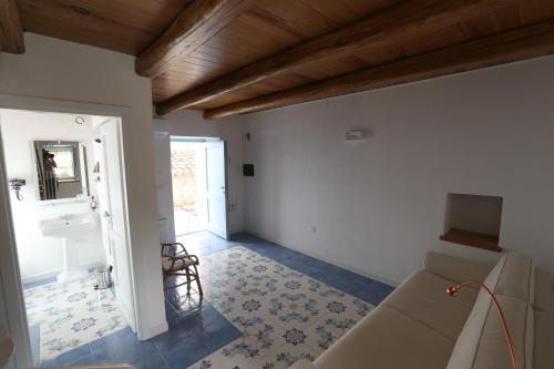 a living room with a couch and a mirror at Borgo Rosso di Sera - Resort Country Chic in San Lucido