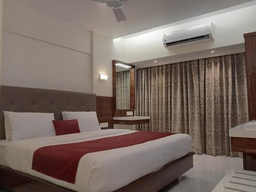 a bedroom with a large bed and a window at Hotel Milan International in Mumbai