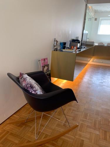 a black chair with a pillow in a room at B&B Yellow Submarine in Antwerp