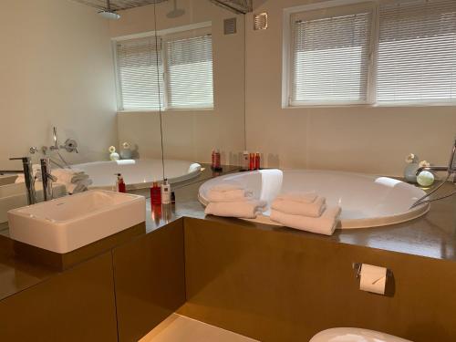 a large bathroom with a tub and a sink at B&B Yellow Submarine in Antwerp