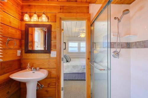 a bathroom with a sink and a shower at Magnolia Cottage in Holden Beach