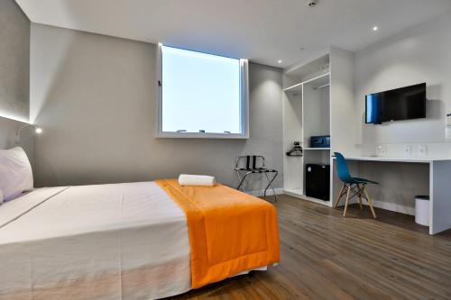 A bed or beds in a room at Go Inn Serra