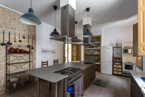 a kitchen with a counter and a stove top oven at Cal Pubill in Ginestar