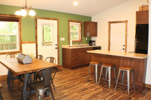 a kitchen with a table and chairs and a counter at Trailhead Suites in Marysville