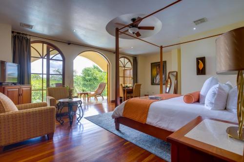 a bedroom with a bed and a living room at San Ignacio Resort Hotel in San Ignacio