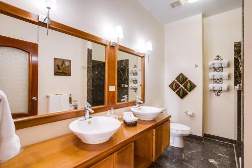 a bathroom with two sinks and a mirror at San Ignacio Resort Hotel in San Ignacio