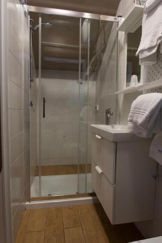 a shower with a glass door in a bathroom at Locanda le Monache in Camaiore