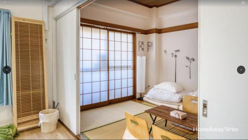 a living room with a table and a bed at V.Close to Shinjuku Kabukicho/Korean Town/FrWIFI C in Tokyo