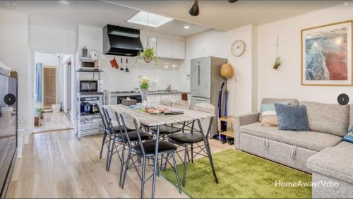 a kitchen and living room with a table and a couch at V.Close to Shinjuku Kabukicho/Korean Town/FrWIFI C in Tokyo