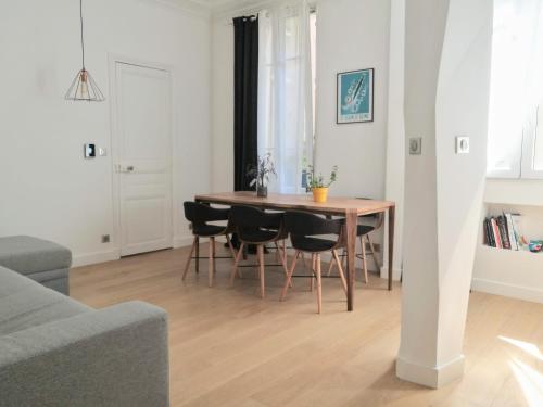 a living room with a dining room table and chairs at Beautiful family flat nearby the Flea Market, Stade de France, Montmartre in Saint-Ouen