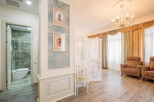 a living room with a chandelier and a bathroom at Hotel Aivani Old Tbilisi in Tbilisi City