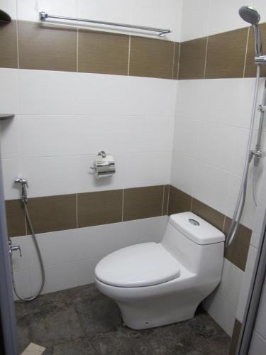 a bathroom with a toilet and a shower at Vynn's @ Banda Kaba in Melaka