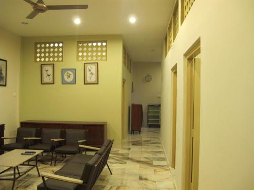 a waiting room with chairs and tables in a building at Vynn's @ Banda Kaba in Melaka