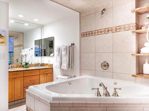 a large bathroom with a tub and a sink at Amelia Island Oceanfront 2 Master Suites in Amelia Island
