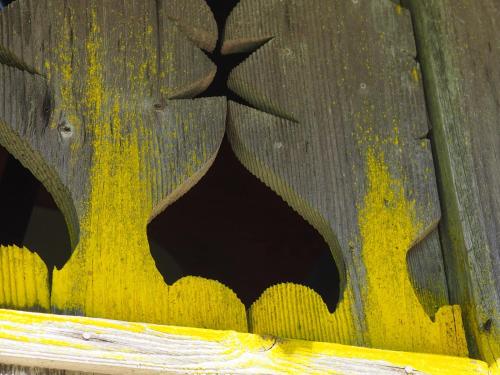 a wooden fence with a bat painted on it at Riversong Centre Thermal in Les Plans-sur-Bex