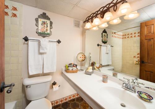 a bathroom with a sink, toilet and bathtub at Inn of the Governors in Santa Fe