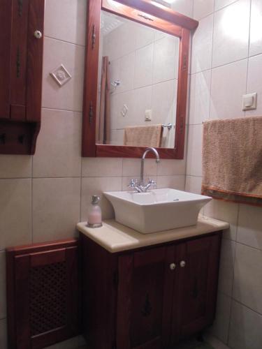 a bathroom with a sink and a mirror at Hillsidehouse in Magouládes