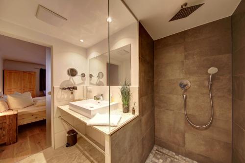 a bathroom with a sink and a shower at Zum Kirchenbauer in Oberammergau