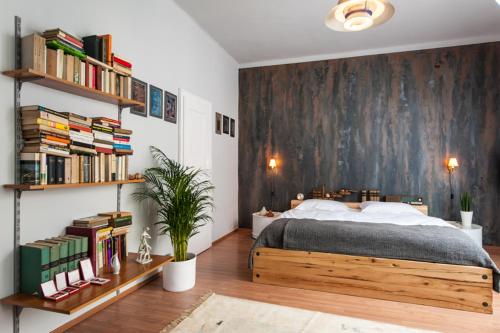 a bedroom with a wooden bed and bookshelves at Europe Heart Apartment for 9 in Budapest